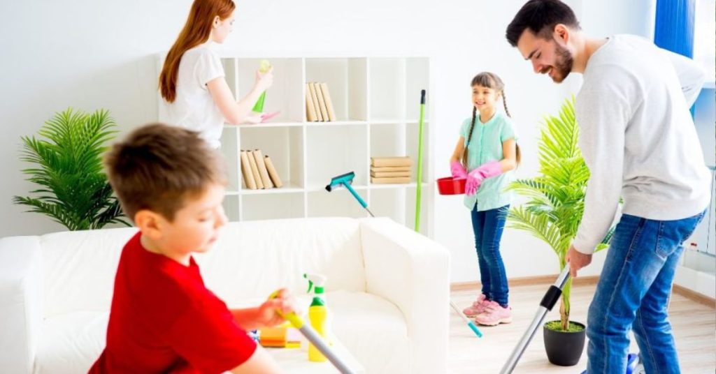 cleaning strategies for large families in avimor - Fabulously Clean kids smiling and helping parents do house cleaning chores in living room on sunny day, cleaning strategies for large families in avimor