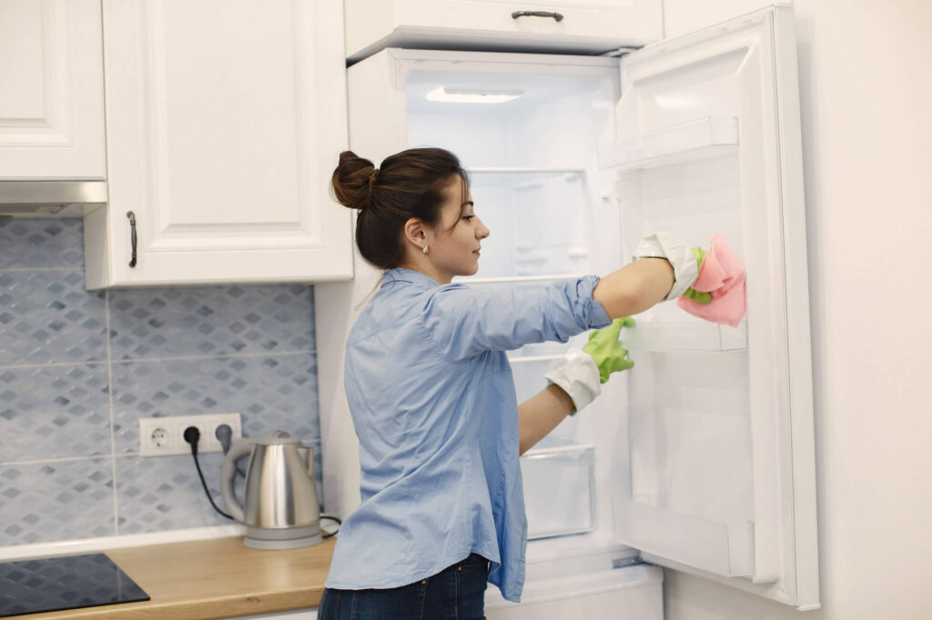 woman cleaning refrigerator
